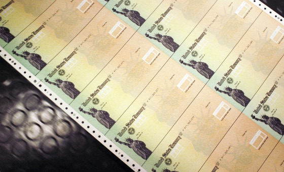 Elderly people reviewing paperwork about social security may payments