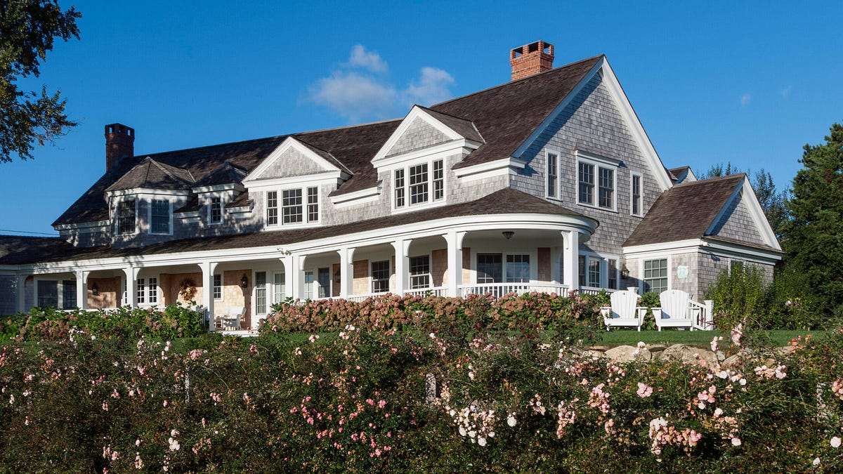 A suburban home with a sold sign and mortgage documents