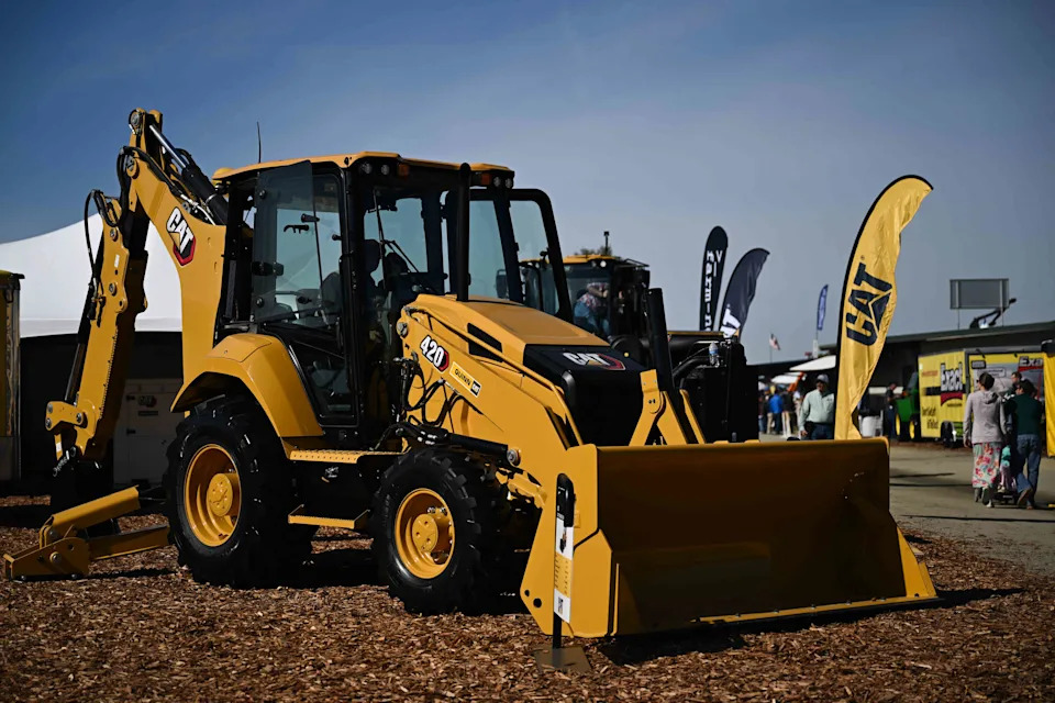Caterpillar machinery with stock chart overlay representing CAT stock performance in 2025