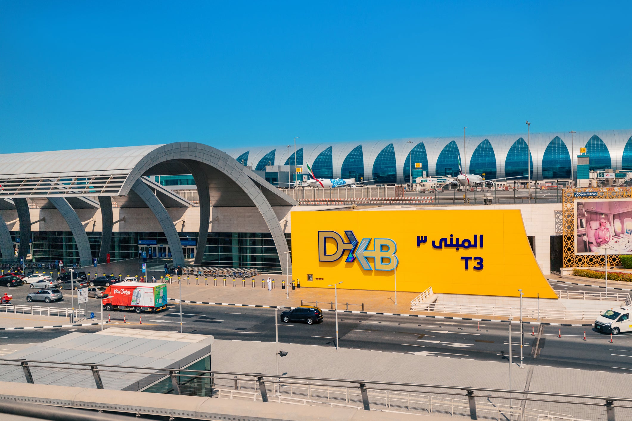 Dubai airport aerial view with DXB and desert expansion