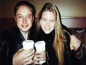Elon Musk at a press event, representing the elon musk net worth discussion