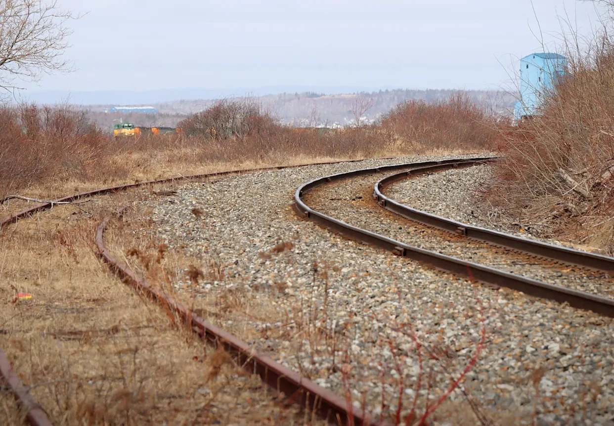 A panoramic view of Nova Scotia's landscape with tracks symbolizing commuter rail development