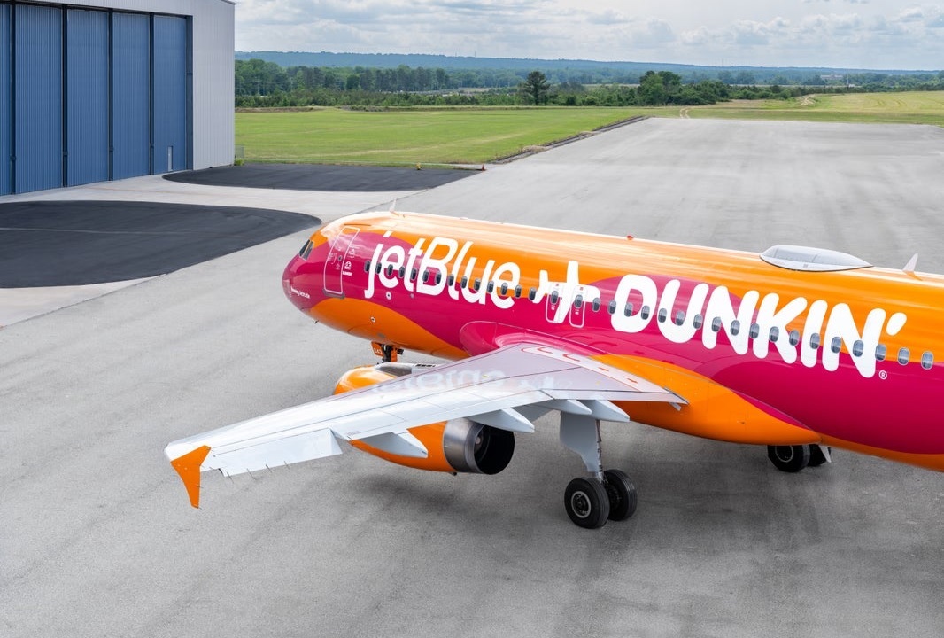 JetBlue "Brewing Altitude" plane featuring Dunkin' themed livery at Logan Airport