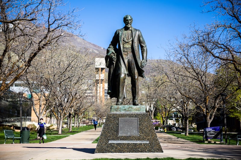 Students walk near the Louis Frederick Moench statue at Weber State University